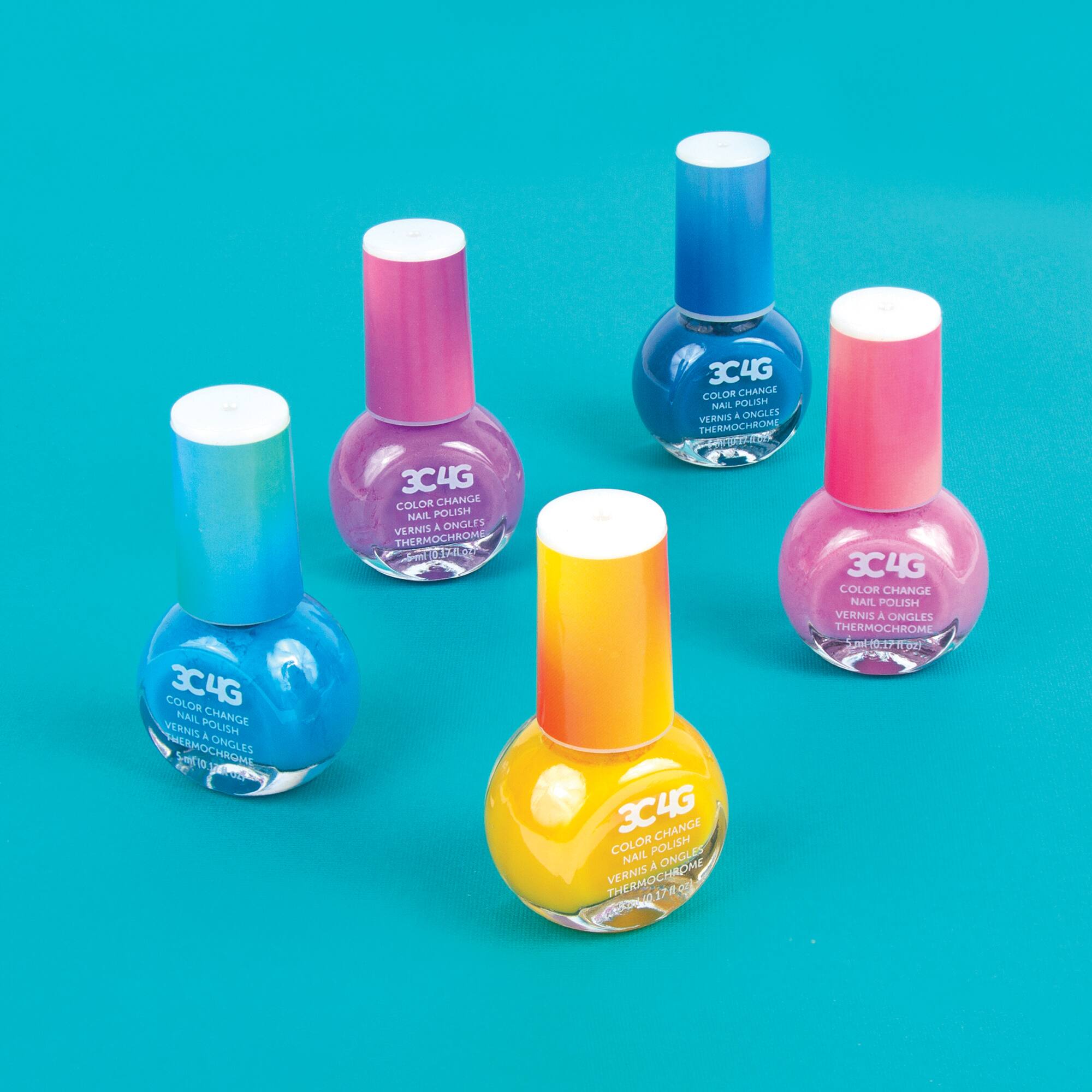 The image features four bottles of nail polish from the brand 3C4G. The bottles are arranged in a row, showcasing the different colors available. The colors include blue, pink, yellow, and purple. The bottles are placed on a blue background, which complements the vibrant colors of the nail polish.