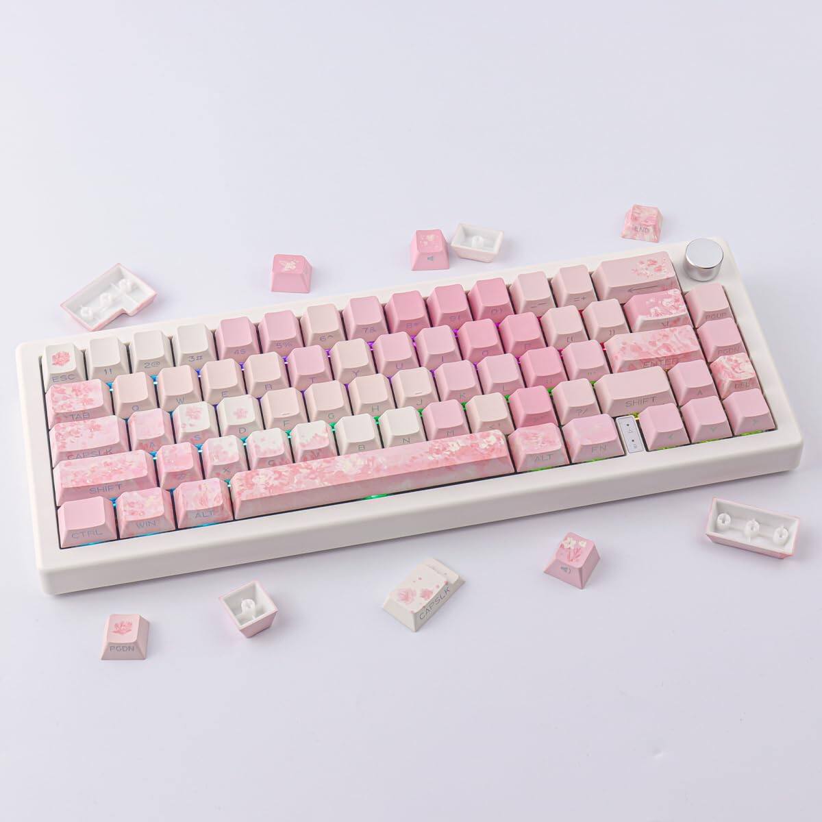 Sure, here is the corrected and grouped text from the image:

**Top Row:**
- Q W E R T Y U I O P

**Second Row:**
- A S D F G H J K L

**Third Row:**
- Z X C V B N M

**Function Keys:**
- ESC 1 2 3 4 5 6 7 8 9 0 - = Backspace

**Modifier Keys:**
- Tab Caps Lock Shift

**Spacebar:**
- Space

**Other Keys:**
- Ctrl Alt Shift

**Special Keys:**
- Enter

**Additional Keys:**
- Fn

**Extra Keys:**
- P O O M

**Keycaps:**
- Some keycaps have floral designs.

**Other:**
- The keyboard has a white base with pink keycaps.