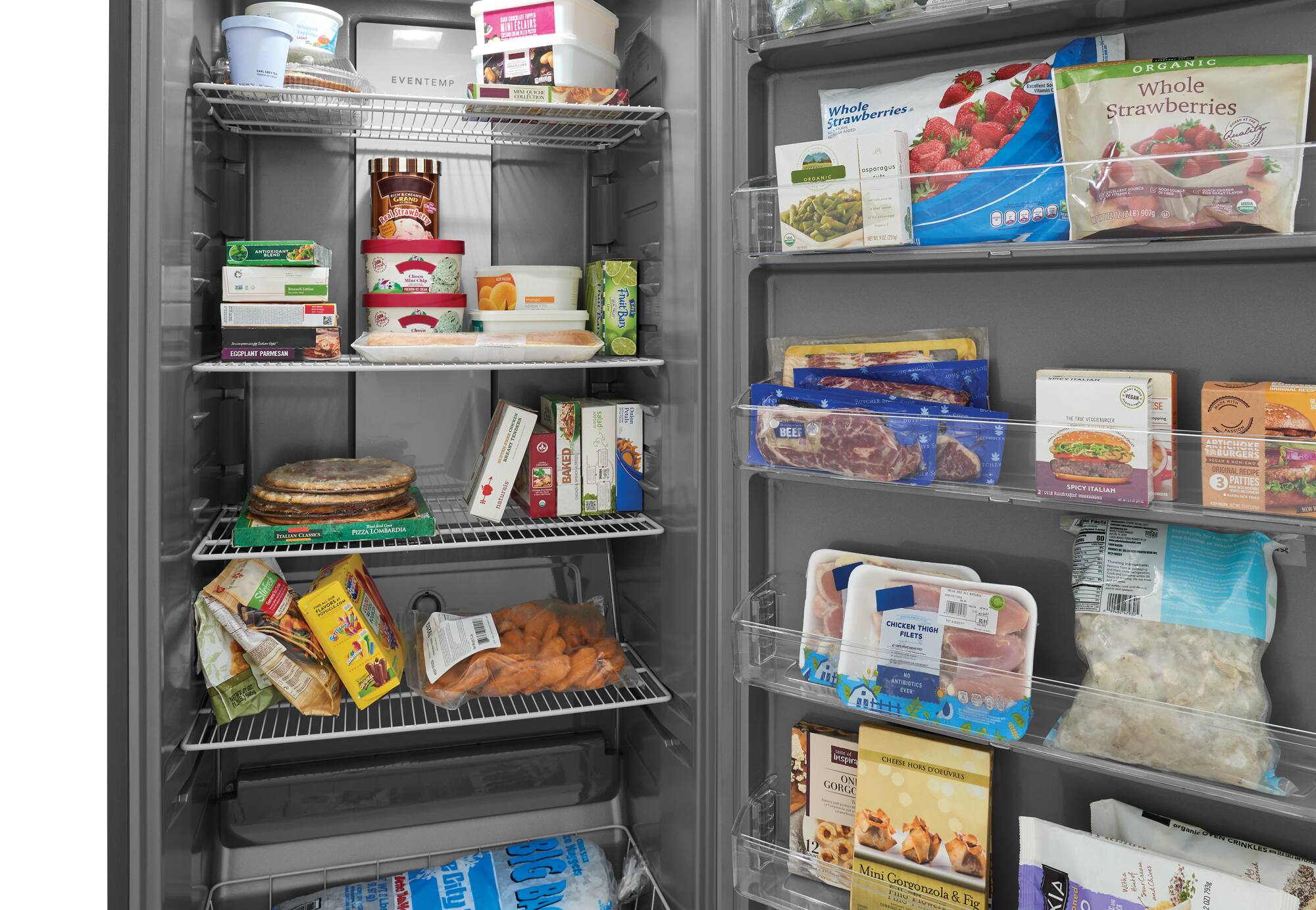 The image shows a refrigerator filled with various food items. There are multiple bottles, including a bottle of strawberries, a bottle of Italian dressing, and a bottle of chicken breasts. There are also several packages of meat, such as beef patties, and a package of chicken thighs. Additionally, there are multiple packages of cheese and a package of bacon. The refrigerator is well-stocked with a variety of food items, making it a convenient and functional space for meal preparation.