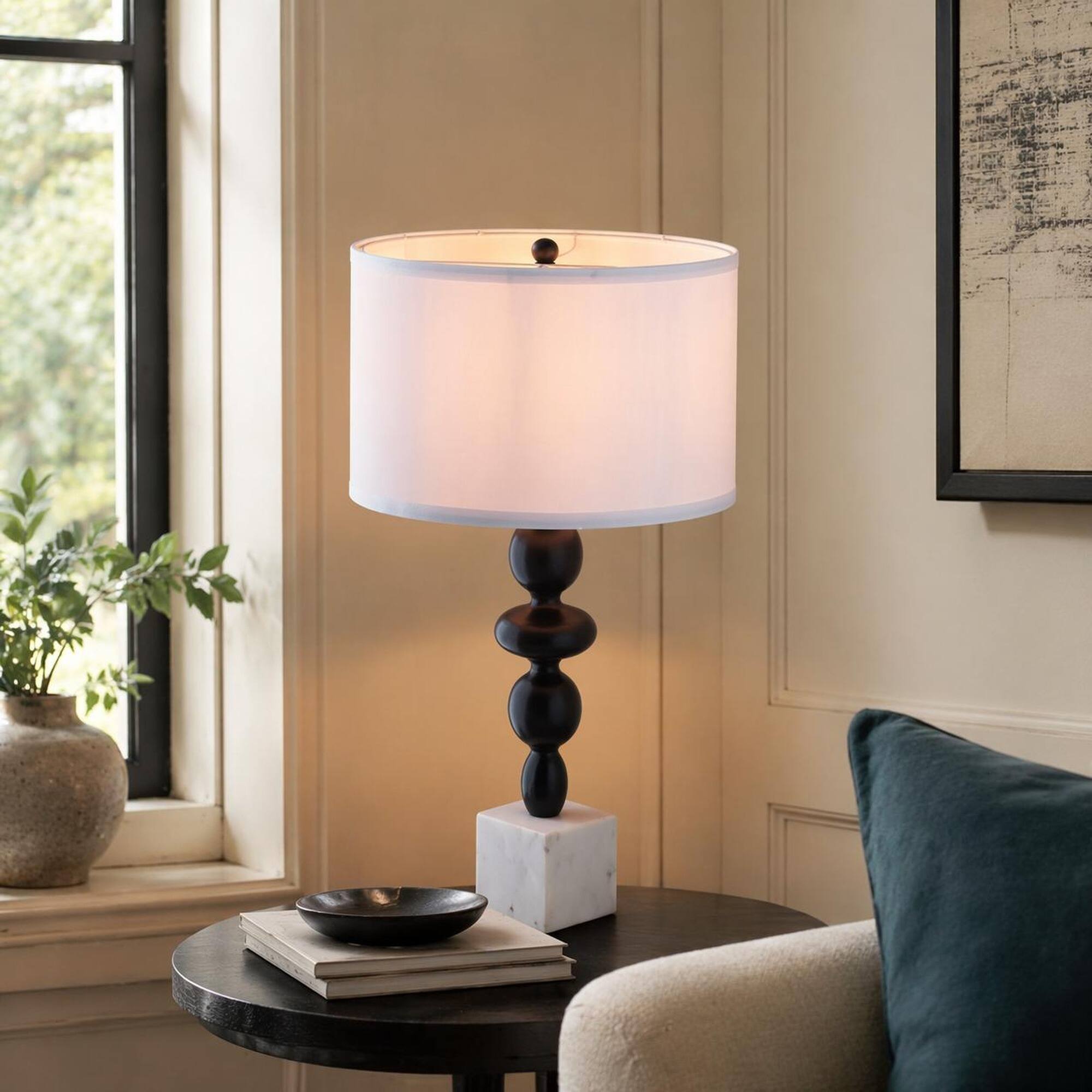 Angle. RYHNUYNE - Black and White Table Lamp with Round Four-Tiered Body, Marble Cube Base, and Fabric Drum Shade - Black White.