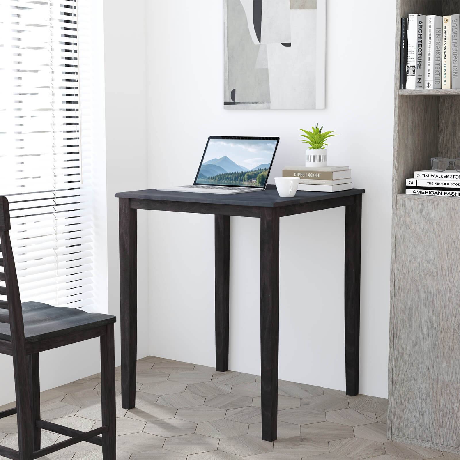 The image shows a small desk with a laptop on it, surrounded by a few books and a potted plant. The desk is positioned in front of a window, providing a pleasant view for the person working at the desk. The books are placed on the desk, and the potted plant is located nearby, adding a touch of greenery to the space. The desk is situated in a room with a chair, and there is a bookshelf in the background. The overall atmosphere of the room appears to be calm and focused, making it an ideal workspace.