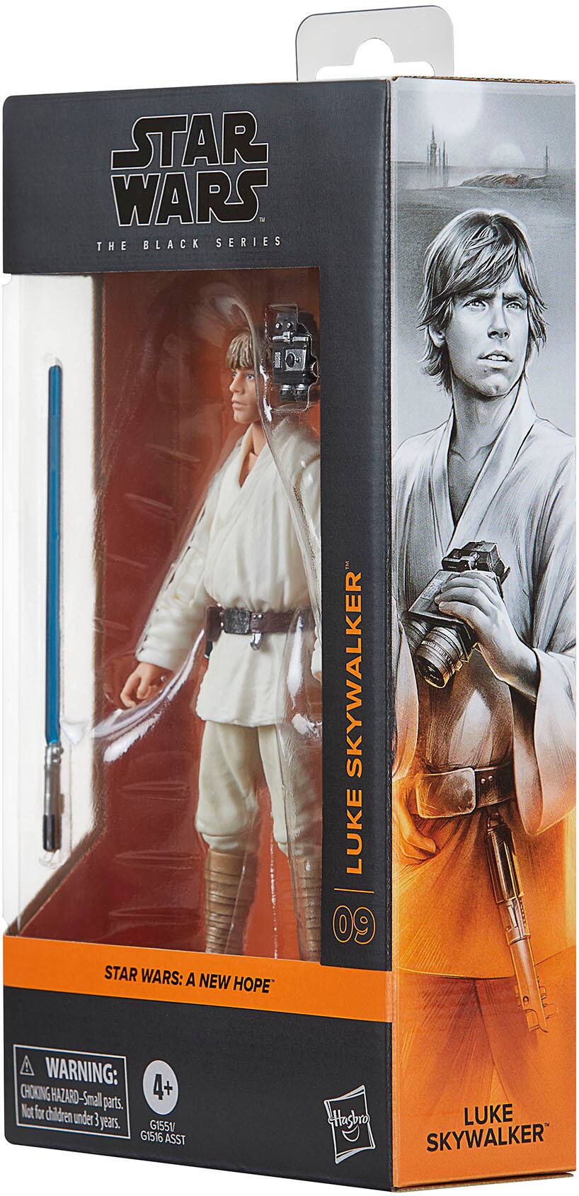 The image features a Star Wars action figure in a box, which is part of the Black Series. The figure is of Luke Skywalker, a character from the Star Wars: A New Hope movie. The box has a warning label that cautions against choking hazards for children under 3 years old. The action figure is designed by Hasbro and is part of the G1551 and GI516 assortments.