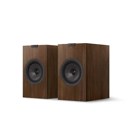 The text on the image reads "TKEF AKEF wN - wA suced oe." However, this text does not provide any information about the image itself. The image features two wooden speakers, which are likely part of a stereo system.