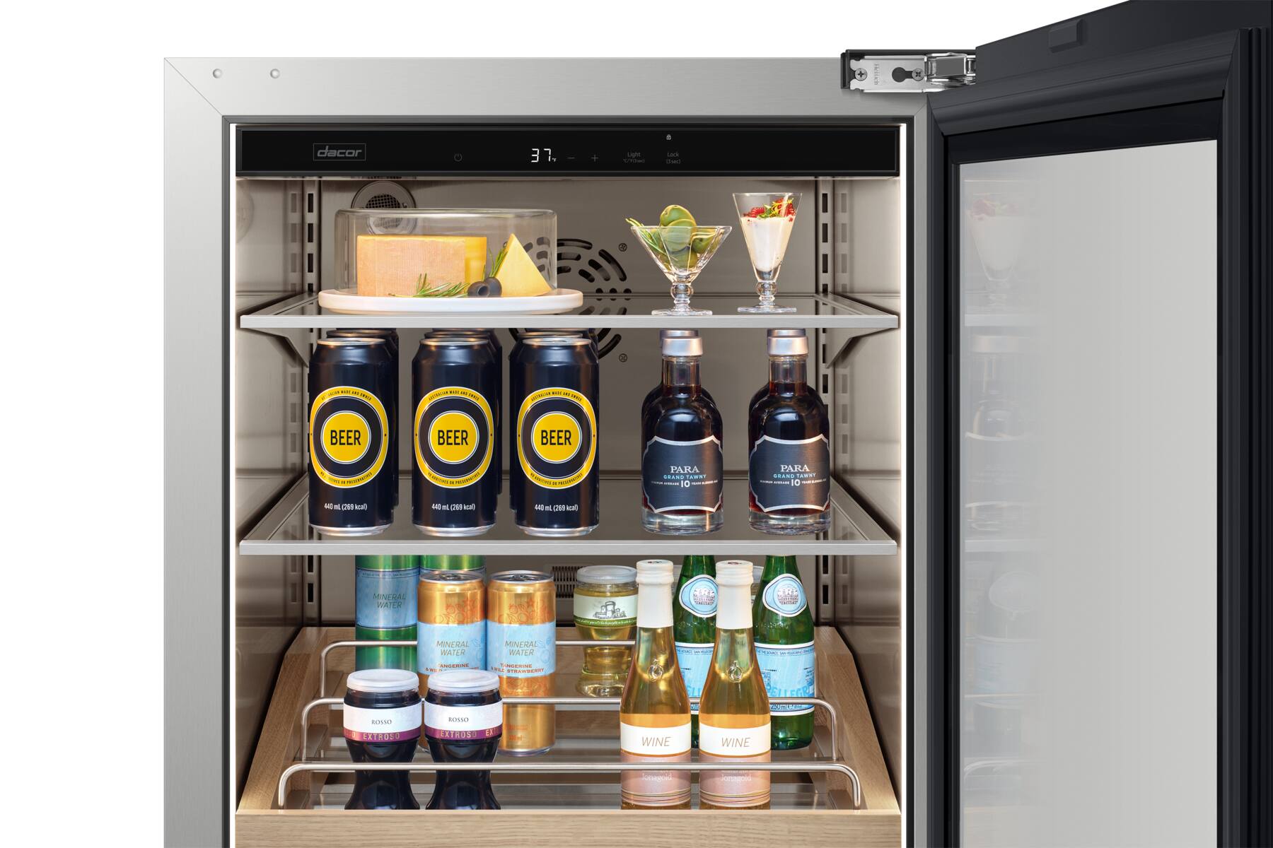 The image shows a refrigerator with a variety of drinks inside. There are several bottles of beer, including a few cans, and a few bottles of wine. The refrigerator also contains a few cups and a bowl. The drinks are organized on shelves, with some bottles placed on the top shelf and others on the bottom shelf. The refrigerator is filled with a diverse selection of beverages, making it a convenient and well-stocked source for refreshments.