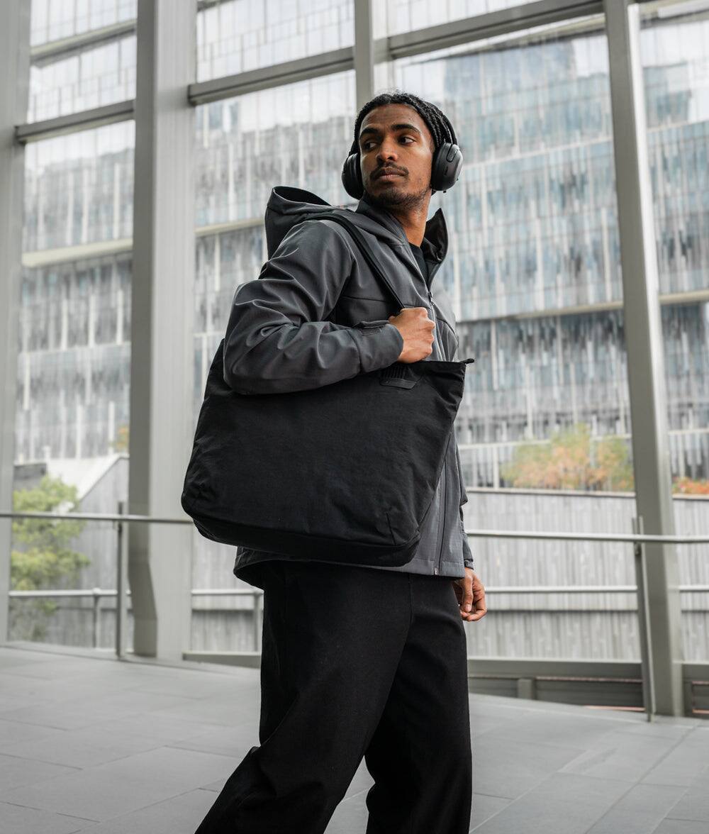 Alt View 10. ALPAKA - Flight Tote (L) Laptop Tote Bag for Work, Large Tote Bag Fits 16" MacBook Pro, Water Bottle Pocket, Luggage Pass-Through - Black Axoflux 400D.