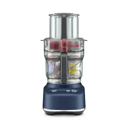 The image features a Breville blender that is blue in color. The blender is filled with various ingredients, including a cup and a bottle. The blender is placed on a countertop, ready for use.