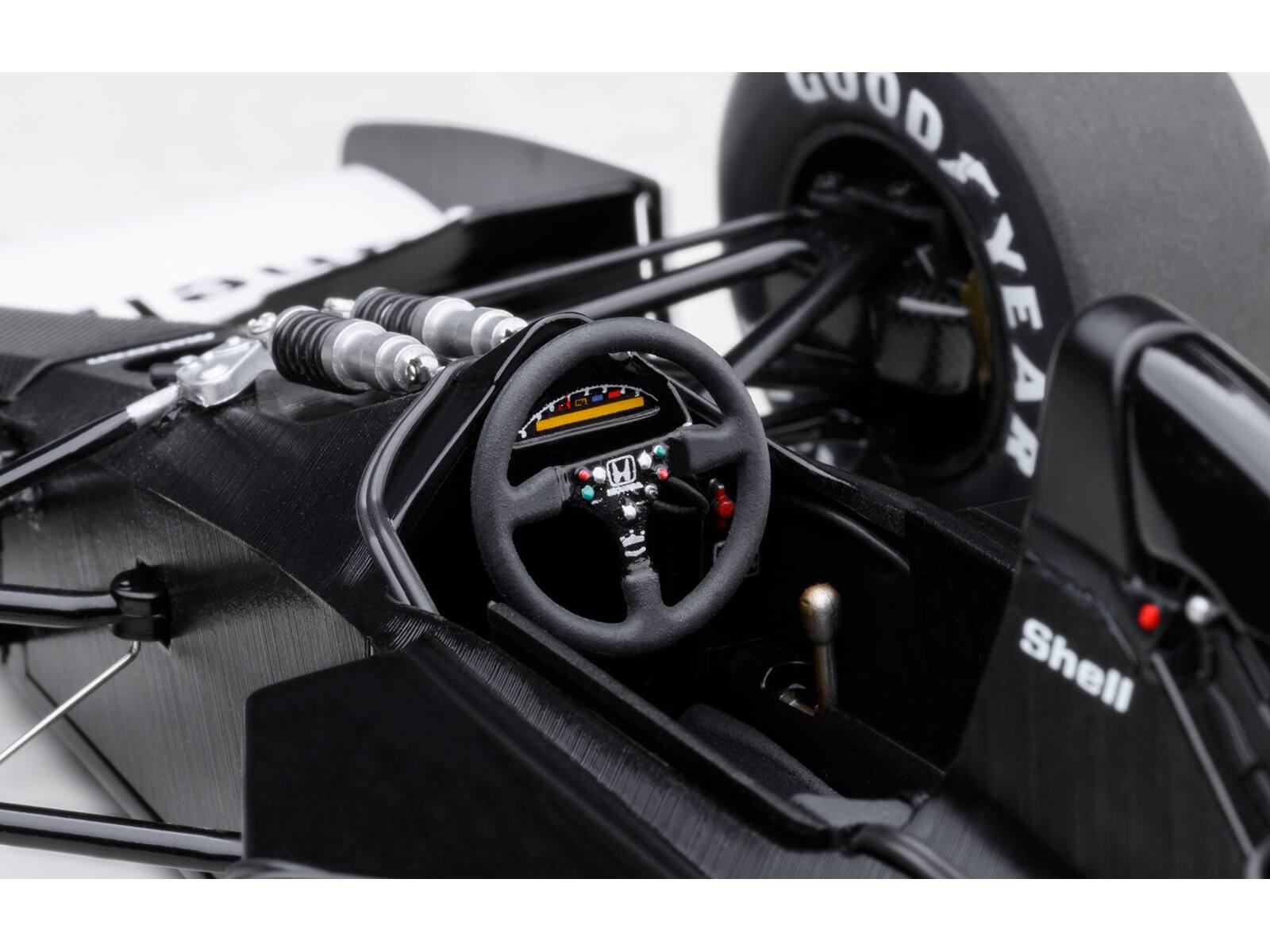 The text in the image reads:

- "GOOD YEAR" (on the tire)
- "Shell" (on the car body)