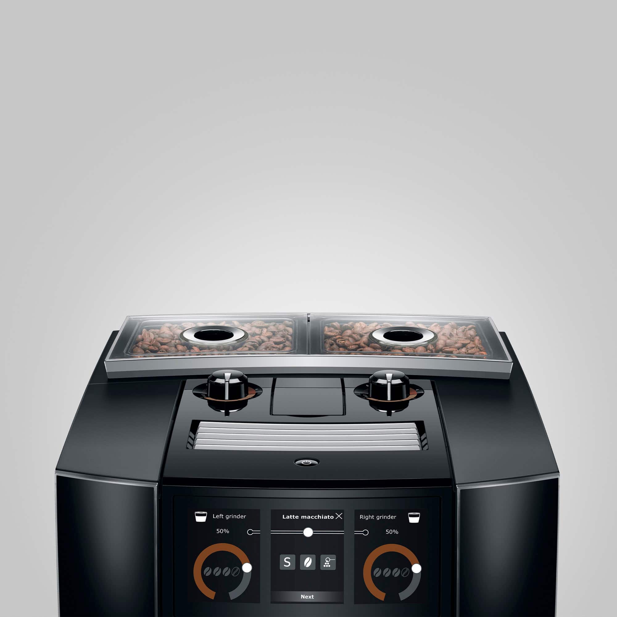 The image features a modern coffee maker with two grinders, one on the left and one on the right. The left grinder is designed for making latte macchiato, while the right grinder is set at 50%. The coffee maker is part of the Nest system, which is a smart home technology that allows users to control various appliances and devices in their home through a single interface.