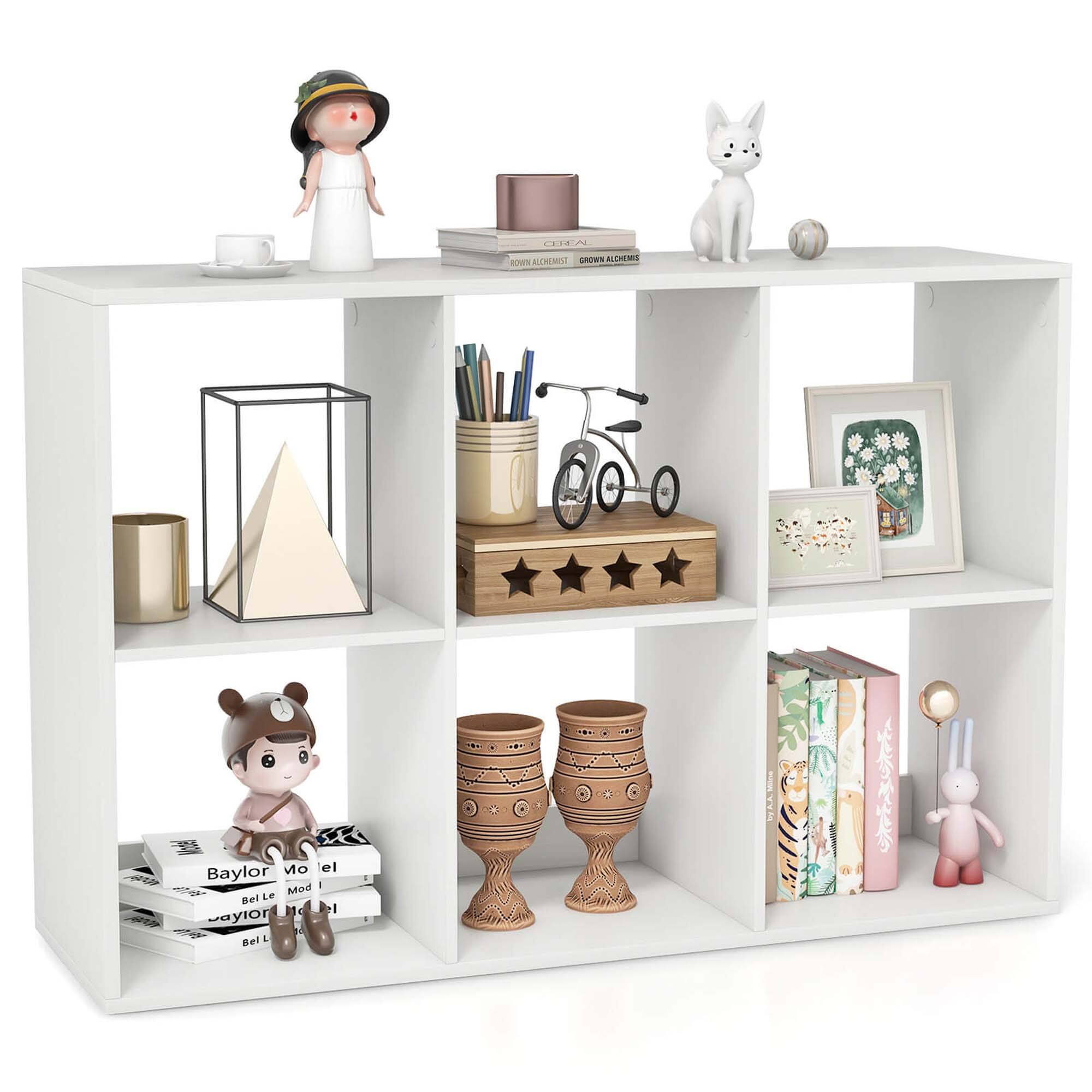 The image features a white shelf with various items on it. There are two vases, one on the left side and the other on the right side of the shelf. A bunny figurine is also present on the left side of the shelf. Additionally, there are two books, one on the left side and the other on the right side of the shelf. A small teddy bear is placed on the right side of the shelf, and a sports ball is located in the middle. A cup can be seen on the left side of the shelf, and a bowl is placed on the right side. A bicycle is also present on the shelf, located in the middle.