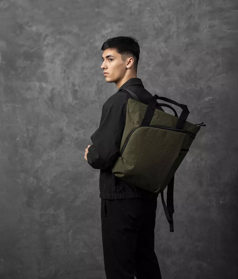 Angle. ALPAKA - Flow Totepack Laptop Backpack for Men, 16" Laptop Compartment + 11" Tablet Sleeve, Tote/Backpack, Bottle Pocket - Green Axoflux 400D Washed Nylon.