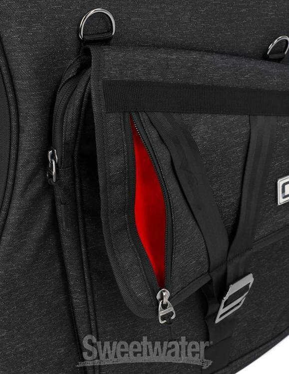 Left. Gator - Transit Series Jumbo Acoustic Guitar Gig Bag with Rigid Internal Frame and Weather-Resistant Exterior - Black.