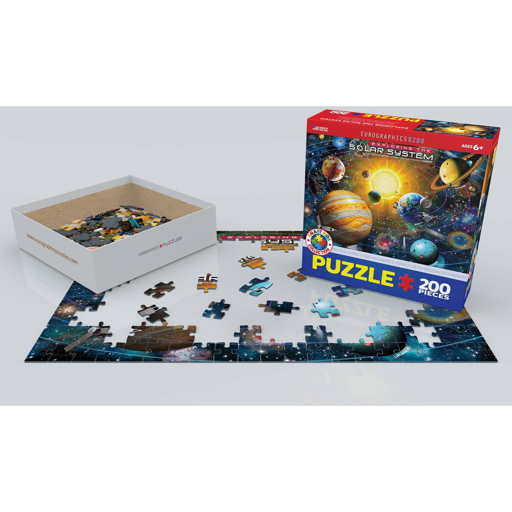 A box of puzzle pieces is shown next to a puzzle board. The puzzle is from the Solar System series and is designed for ages 6+. The puzzle has 200 pieces and is made by Eurographics. The puzzle is displayed on a white background, and the box is placed next to the puzzle board.