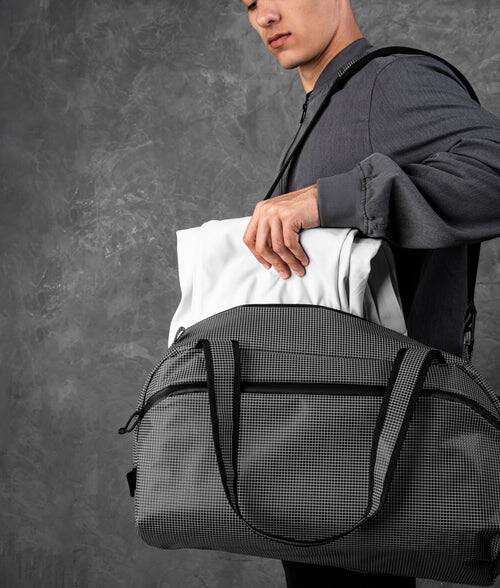 Back. ALPAKA - 35L Lightweight Duffel Bag for Gym, Weekend Trips & Carry-On Travel, Momentum Duffel, Weather-Resistant - Axodyne hybrid Grey.