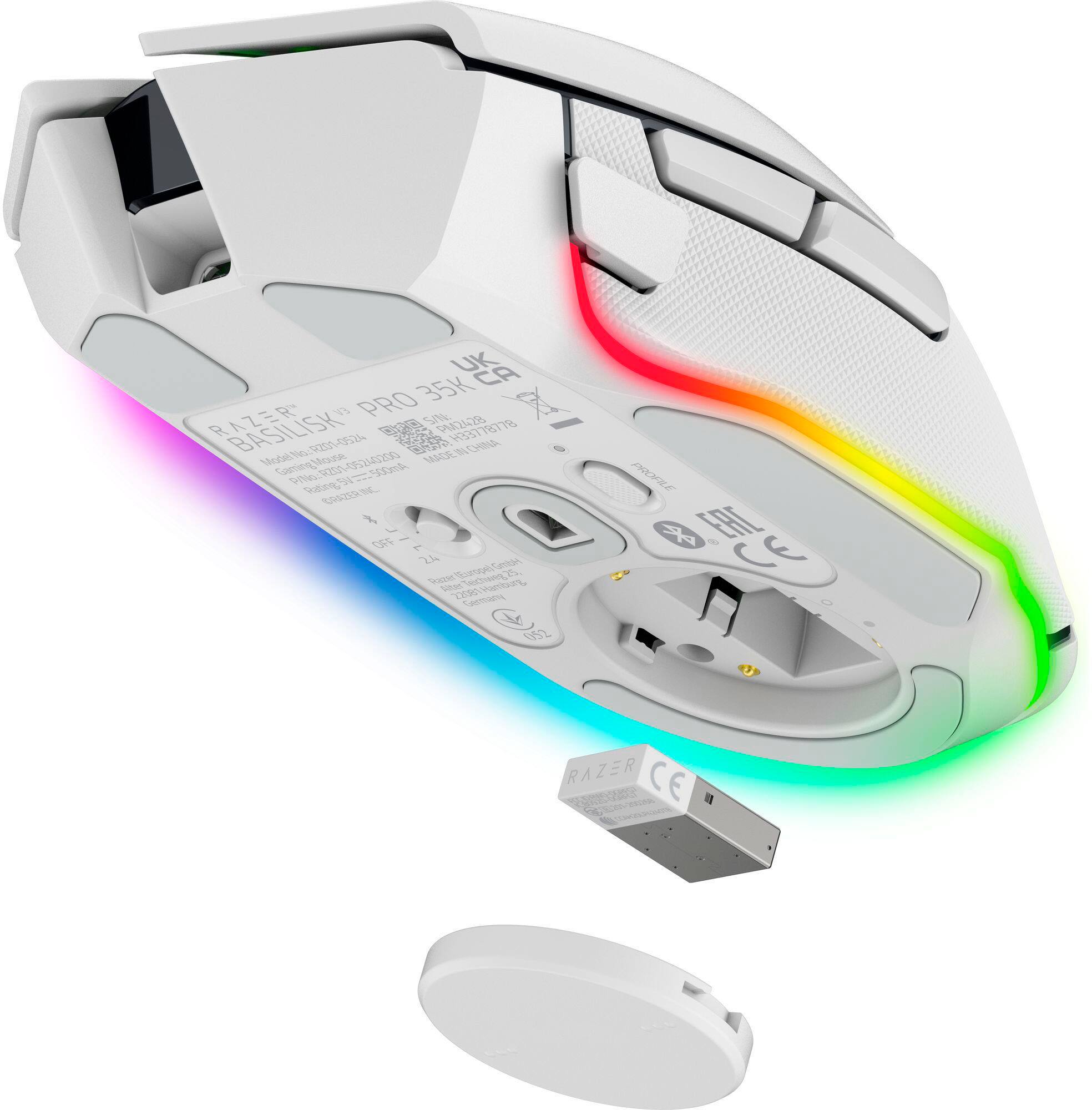 The image shows a white computer mouse with a rainbow light on it. The text on the image reads "Razer CE I AE 35K 3378-9001-062 -5A CEC MADES IN CHINA MODEL CGAMOG MOZA 94 SA ONG ORDRRE + OFF 1 2h CENTRE, S S OC fete E Cme 052 PROPILE P 8".