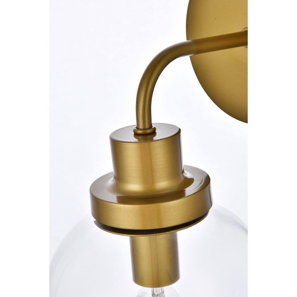 Back. Living District - Hanson 1 light bath sconce in brass with clear shade - Brass And Clear Shade.