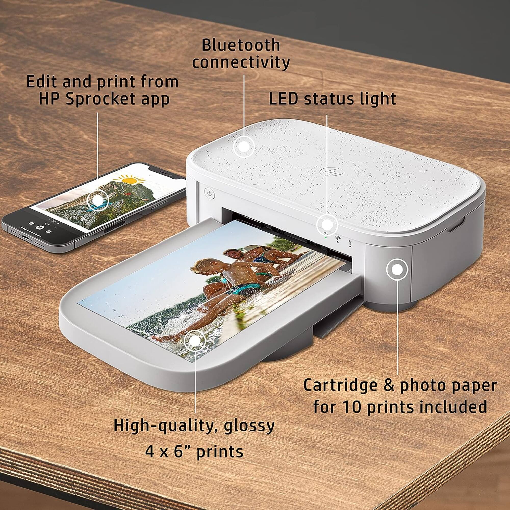 The image features a small white device that is a printer and a scanner. It is designed to print and edit photos from the HP Sprocket app, which offers Bluetooth connectivity. The device has a LED status light, indicating its current status. It also comes with cartridge and photo paper for 10 prints, ensuring high-quality, glossy 4 x 6" prints.