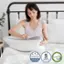 Tencel is a type of foam made in the USA with a 5-year warranty. It is a flexible, certified polyurethane foam that contains CertiPUR-US foam. The image shows a woman sitting on a bed with a pillow, which is made of Tencel foam.