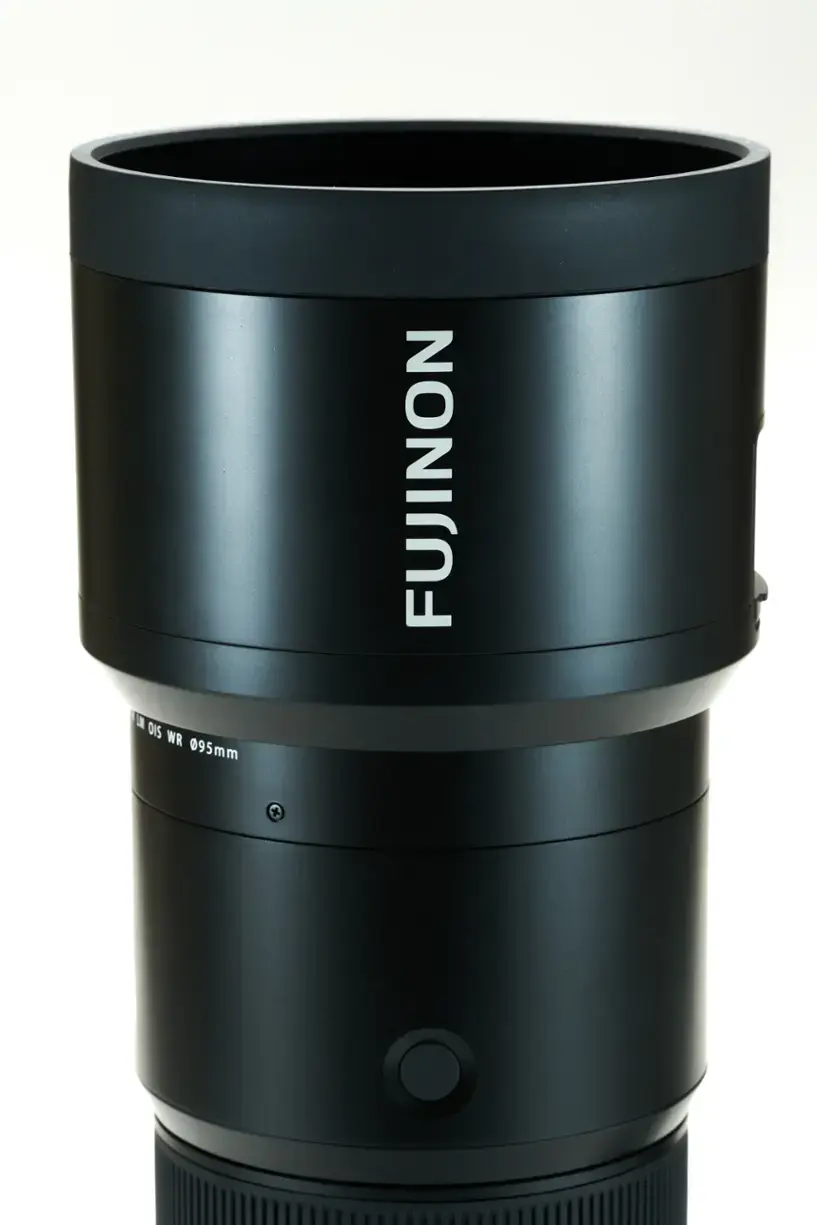 The image features a large black lens, which is a Fujinon lens. It is a zoom lens with a focal length of 0.95mm. The lens is designed for use with a camera, and it is positioned on a white background, making it the main focus of the image.