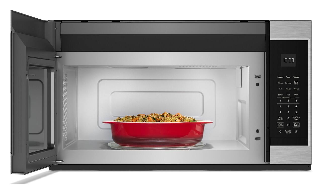 The image shows a microwave with two red bowls of food inside. The microwave is set to cook the food, and the timer is set to 12:03. The microwave is a countertop model, and the food appears to be a mix of potatoes and vegetables. The microwave is a convenient appliance for quickly heating and cooking meals, making it a popular choice for busy households or those looking for a quick and easy dinner option.