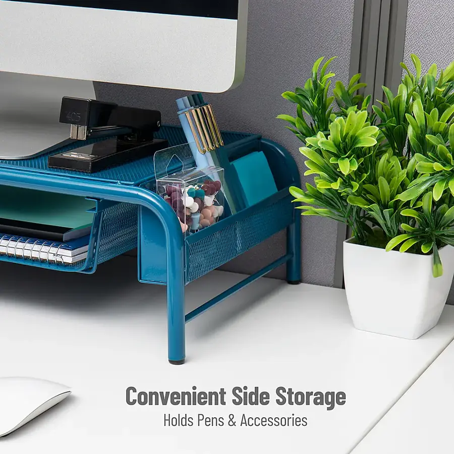The image features a blue desk organizer with a white vase containing green plants. The desk organizer is designed to hold pens and accessories, providing a convenient side storage solution. The plants add a touch of nature to the workspace, creating a pleasant and organized environment.