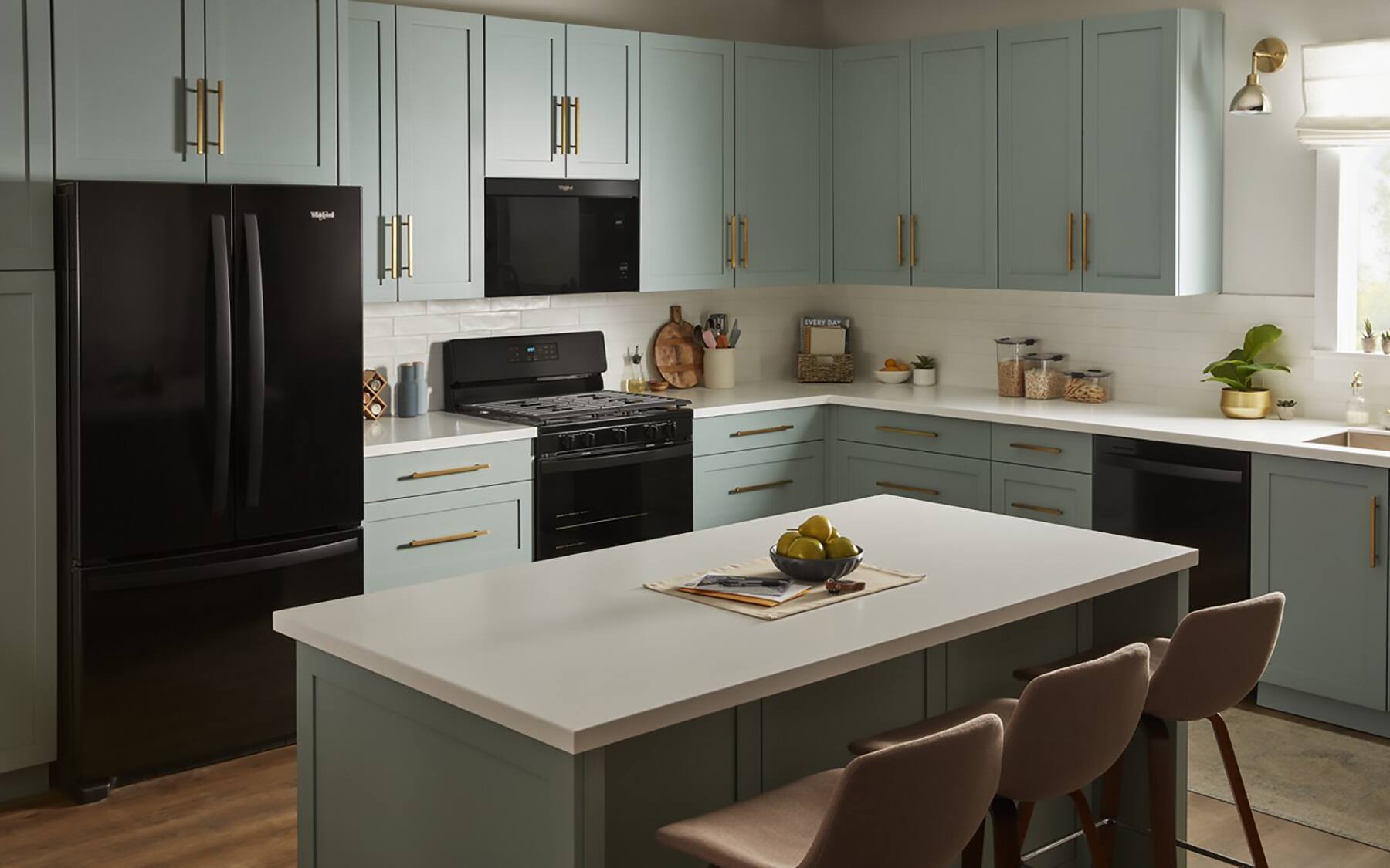 "Big picture of a kitchen with a white countertop and a black refrigerator."
