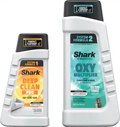 The image features two bottles of Shark carpet cleaning products. One bottle is labeled "Deep Clean Pro," while the other is labeled "Oxy Multiplier." Both bottles are designed for use with Shark Compact & Upright Carpet Cleaners and are compatible with System Formula 1. The products are intended for use on carpets and area rugs, providing instant and permanent odor elimination, as well as stain-striking capabilities. The bottles are placed next to each other, showcasing the variety of cleaning solutions offered by the Shark brand.