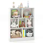 The image shows a white shelf with various toys and items on it. There are several books, including a children's book, and a toy car. Additionally, there are two teddy bears, one of which is placed in a basket. The shelf also has a toy train and a toy boat, as well as a toy carousel. There is a toy truck and a toy airplane on the shelf as well. The shelf is filled with a variety of toys and items, creating a playful and inviting atmosphere.