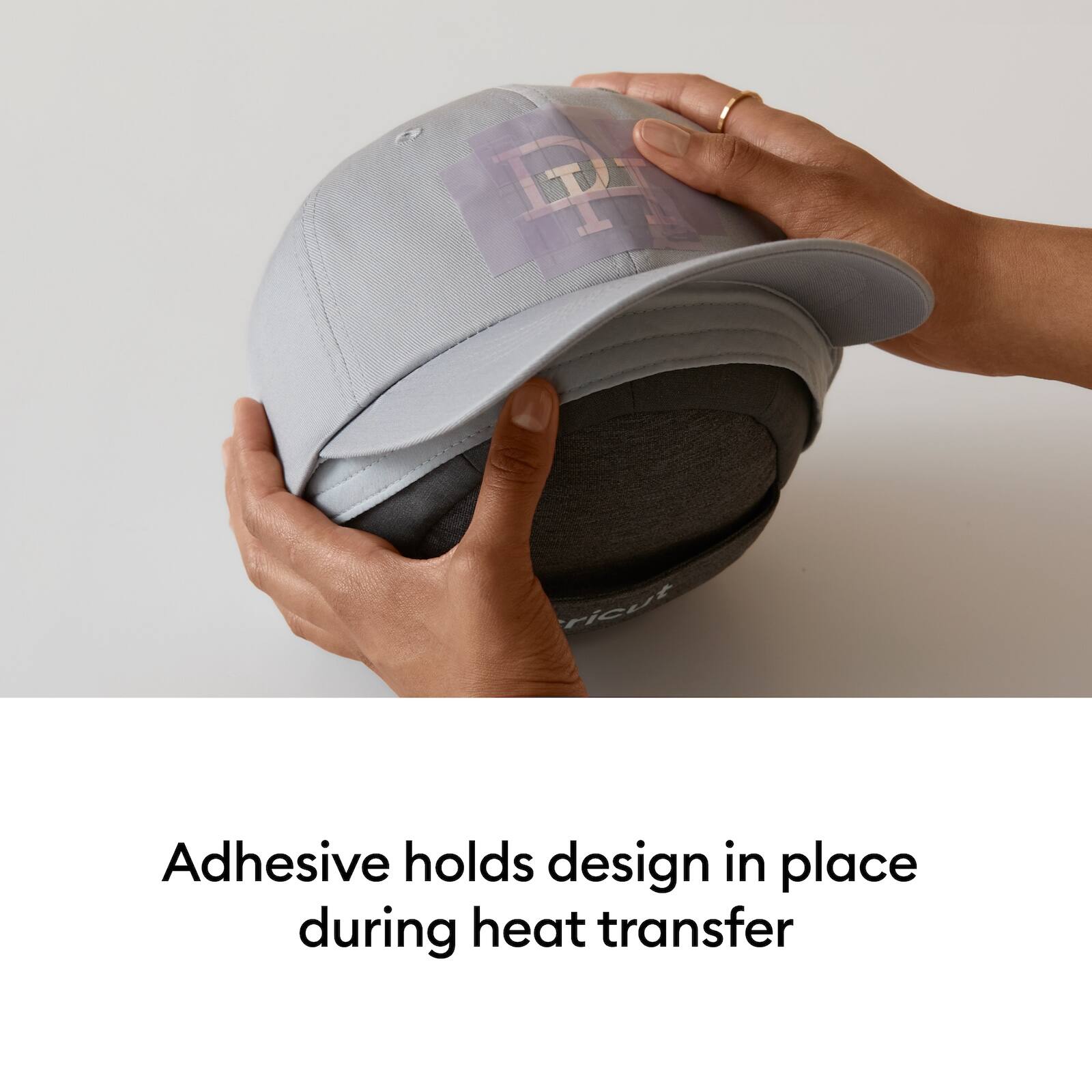 Adhesive holds design in place during heat transfer
