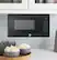 Left. GE - 0.7 Cu. Ft. Spacemaker Countertop Microwave Oven - Black on Black.