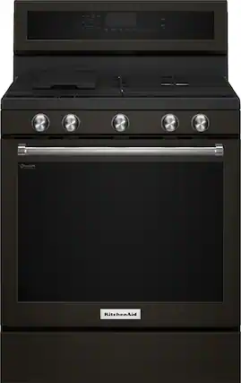 The image features a large black gas range oven with a stainless steel finish. The oven has a stove top and a built-in oven, making it a versatile and functional appliance for cooking. The oven is designed by KitchenAid, a well-known brand known for its high-quality kitchen appliances. The oven's size and features make it suitable for various cooking needs, from preparing small meals to hosting large gatherings.