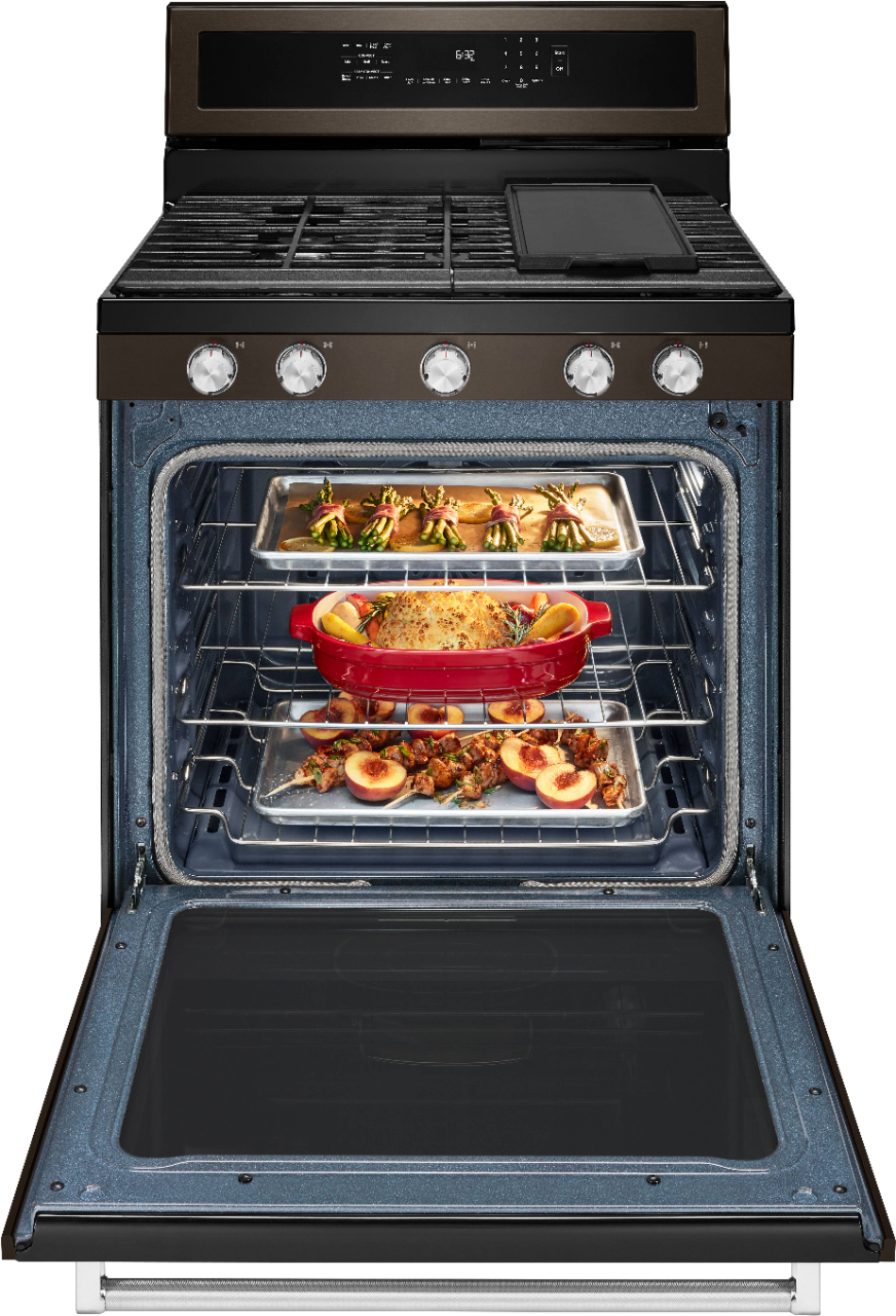 The image features a gas range with a black grill top. There are four burners on the stove, with one burner being larger than the others. The burners are arranged in a square pattern, with one burner on each side of the stove. The stove is turned off, indicating that it is not in use at the moment.