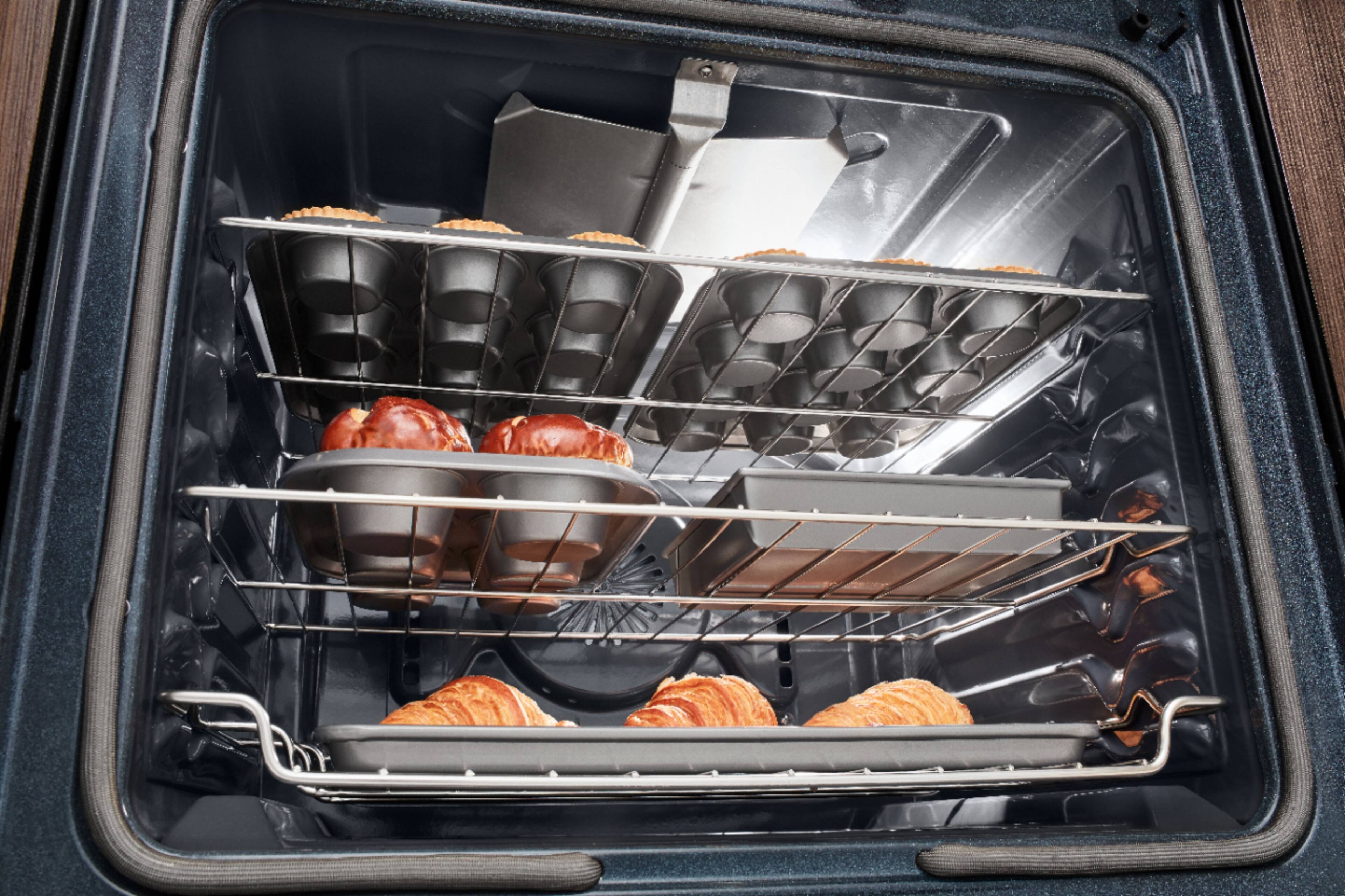 The image features a large appliance, possibly a refrigerator or a freezer, with its back panel removed. The back panel is white, and there are several wires and cords visible inside the appliance. The appliance has a warning label on the back panel, which is likely to provide safety instructions or guidelines for the user.