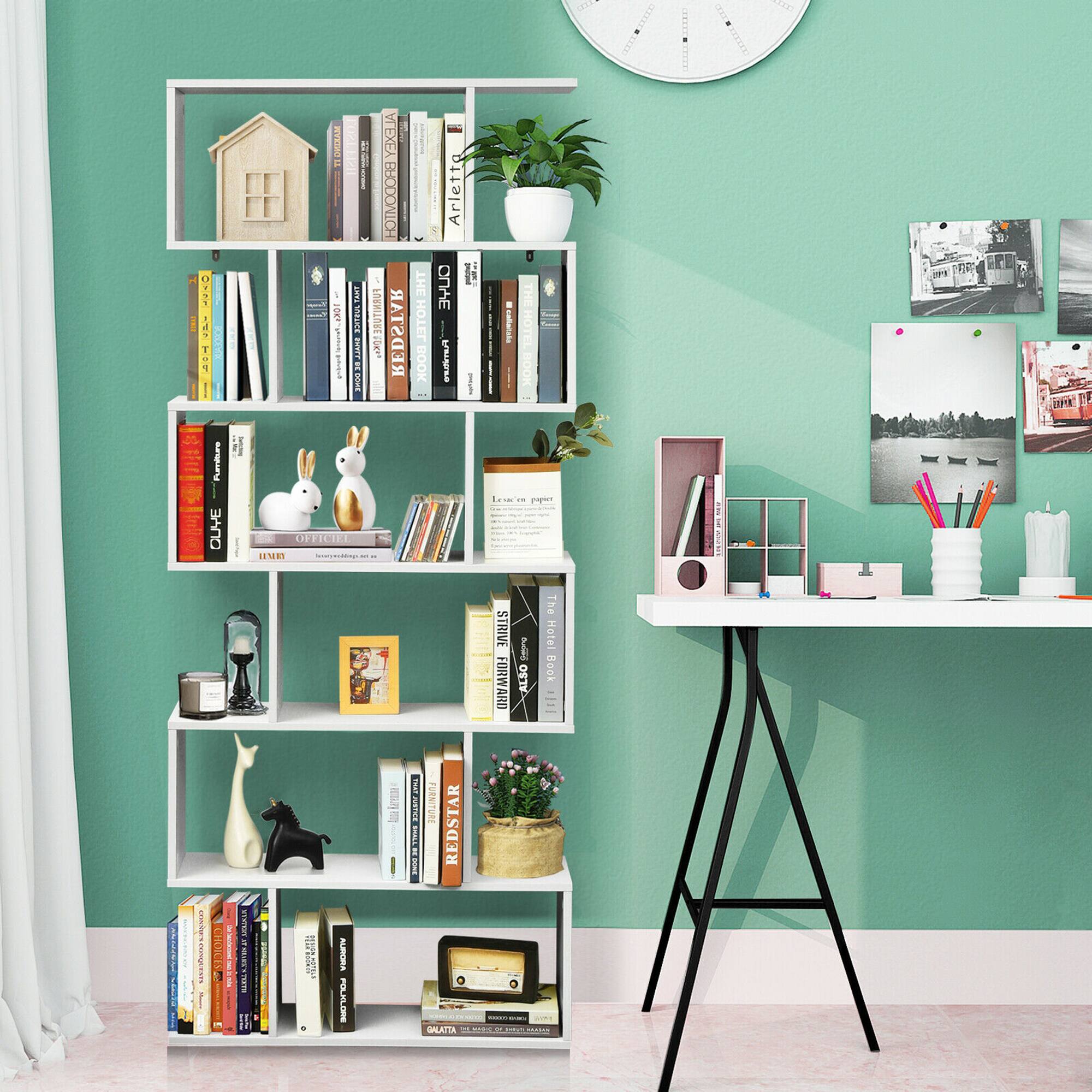 The image features a bookshelf filled with various books, a clock, a potted plant, and a vase. The bookshelf is located next to a desk, which has a laptop, a cup, and a pair of scissors on it. The scene also includes a table with a clock and a vase on it. The books on the bookshelf are arranged in different positions, and the overall setting appears to be a cozy and organized workspace.
