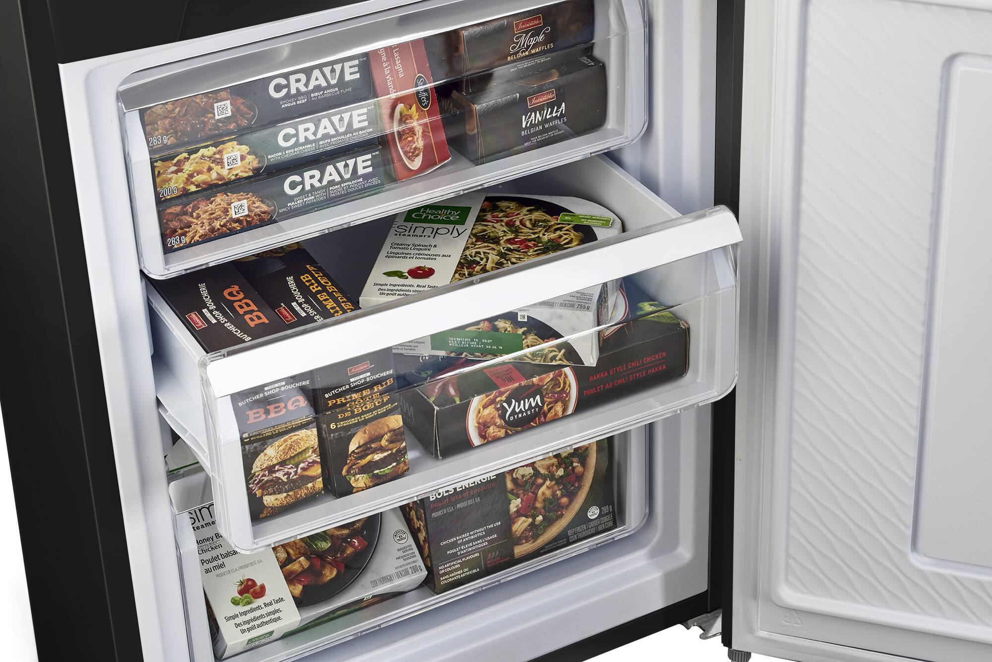 The image shows a refrigerator with its door open, revealing various food items inside. The refrigerator is filled with different types of food, including Crave products. There are at least 12 different food items visible in the refrigerator, with some of them placed in the door compartments. The refrigerator is well-stocked, offering a variety of options for meals and snacks.