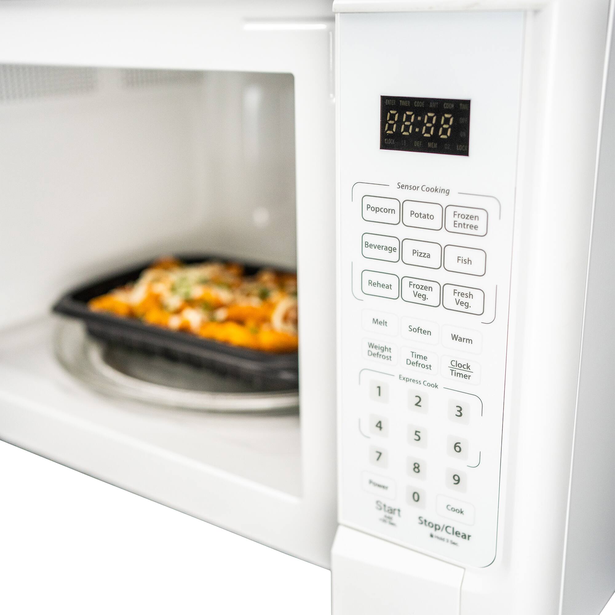 Sensor Cooking Popcorn Potato Frozen Entree Beverage Pizza Fish Reheat Frozen Veg. Fresh Veg. Melt Soften Warm Weight Defrost Time Defrost Clock Express Timer Cook 1 2 3 4 5 6 7 8 9 0 Start Cook Stop/Clear