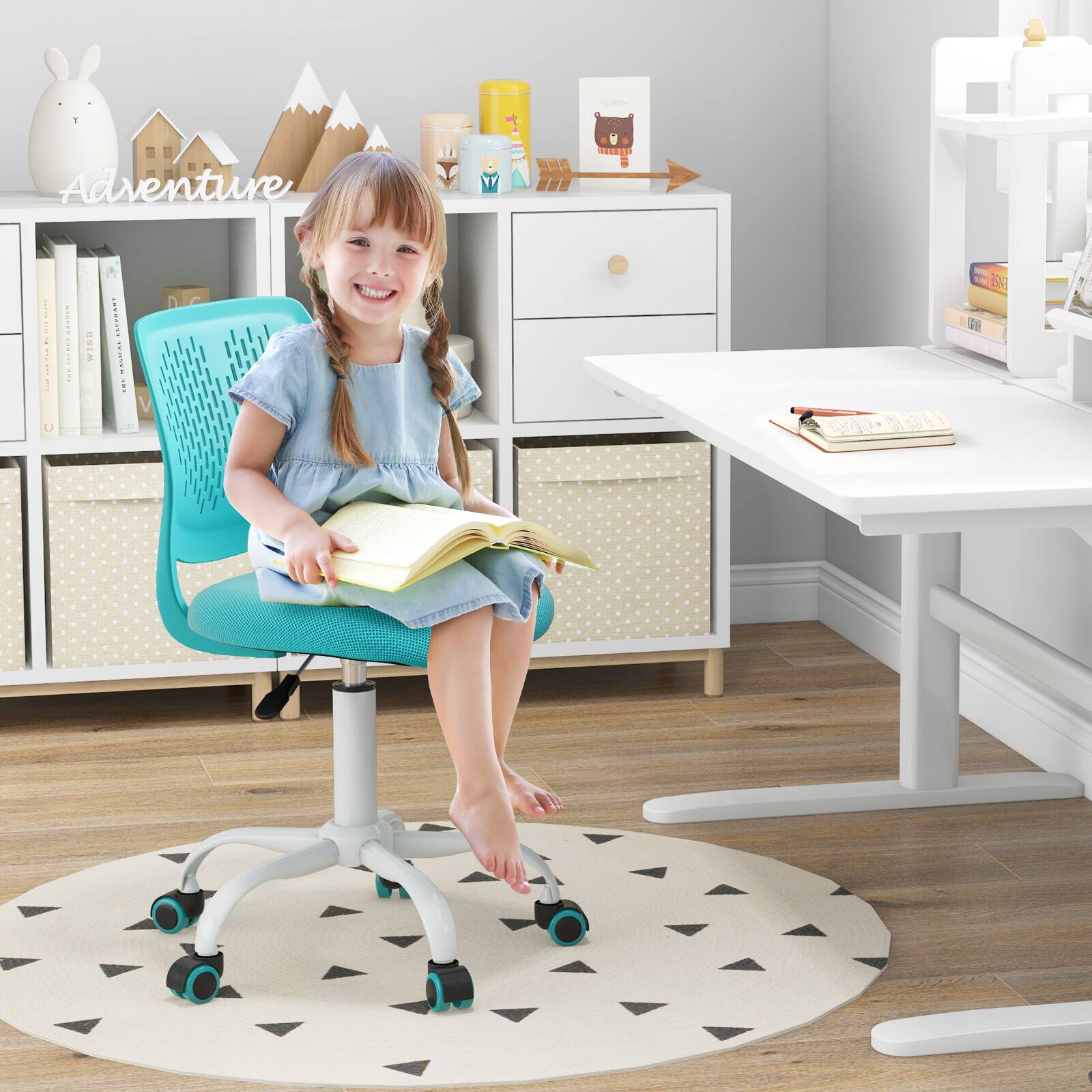 Adventure: A young girl sitting at a desk, reading a book.