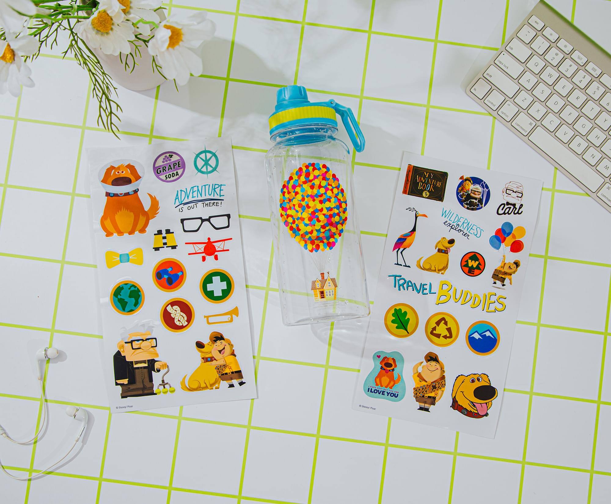 **Grape Soda Adventure**

- Adventure is out there!
- Carl Wilderness Explorer
- Travel Buddies
- I love you

**Stickers:**
- Binoculars
- Airplane
- Camera
- First Aid
- Compass
- Dog with backpack
- Bird
- Giraffe
- Dog with hat
- Dog with backpack
- Leaf
- Recycling symbol
- Mountain
- I love you

**Other Items:**
- Water bottle with colorful beads
- Keyboard
- Earphones
- Flowers