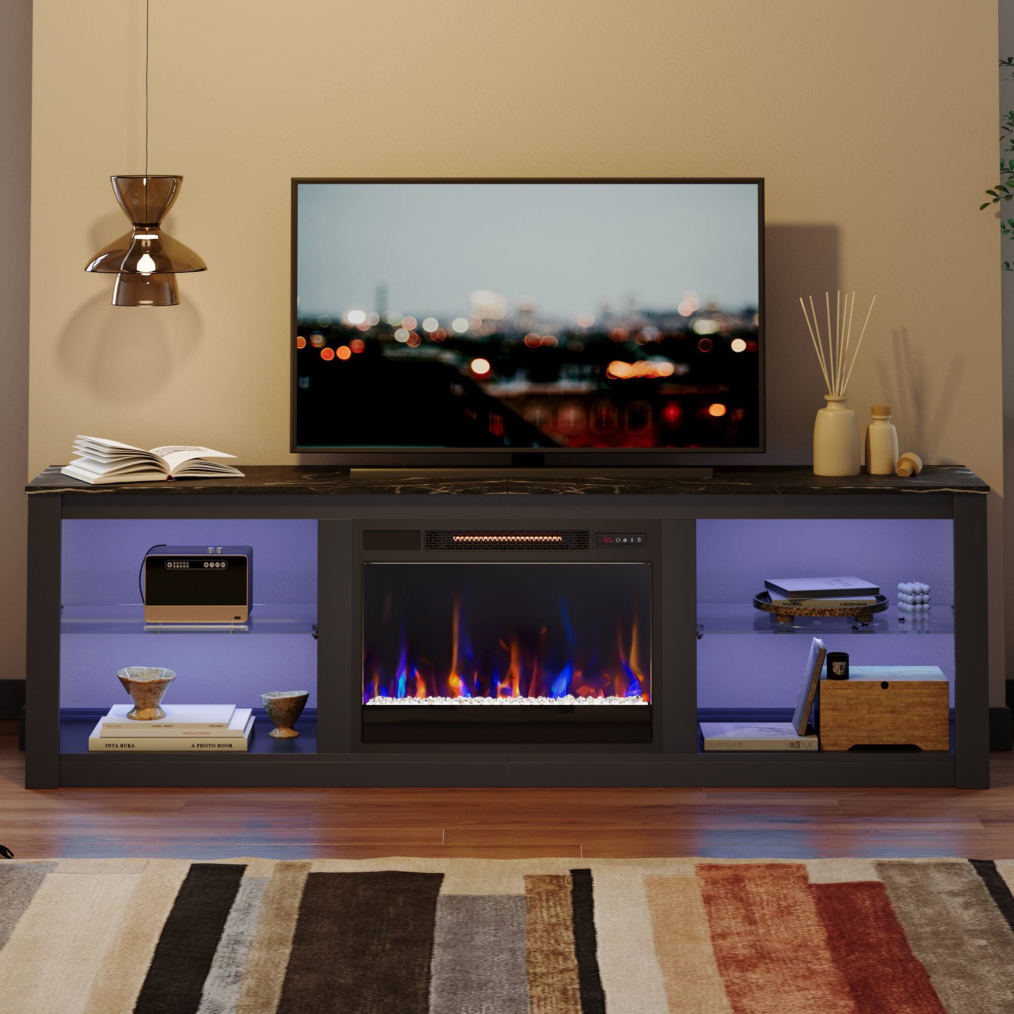D. - A fireplace with a fire going under a flat screen TV.