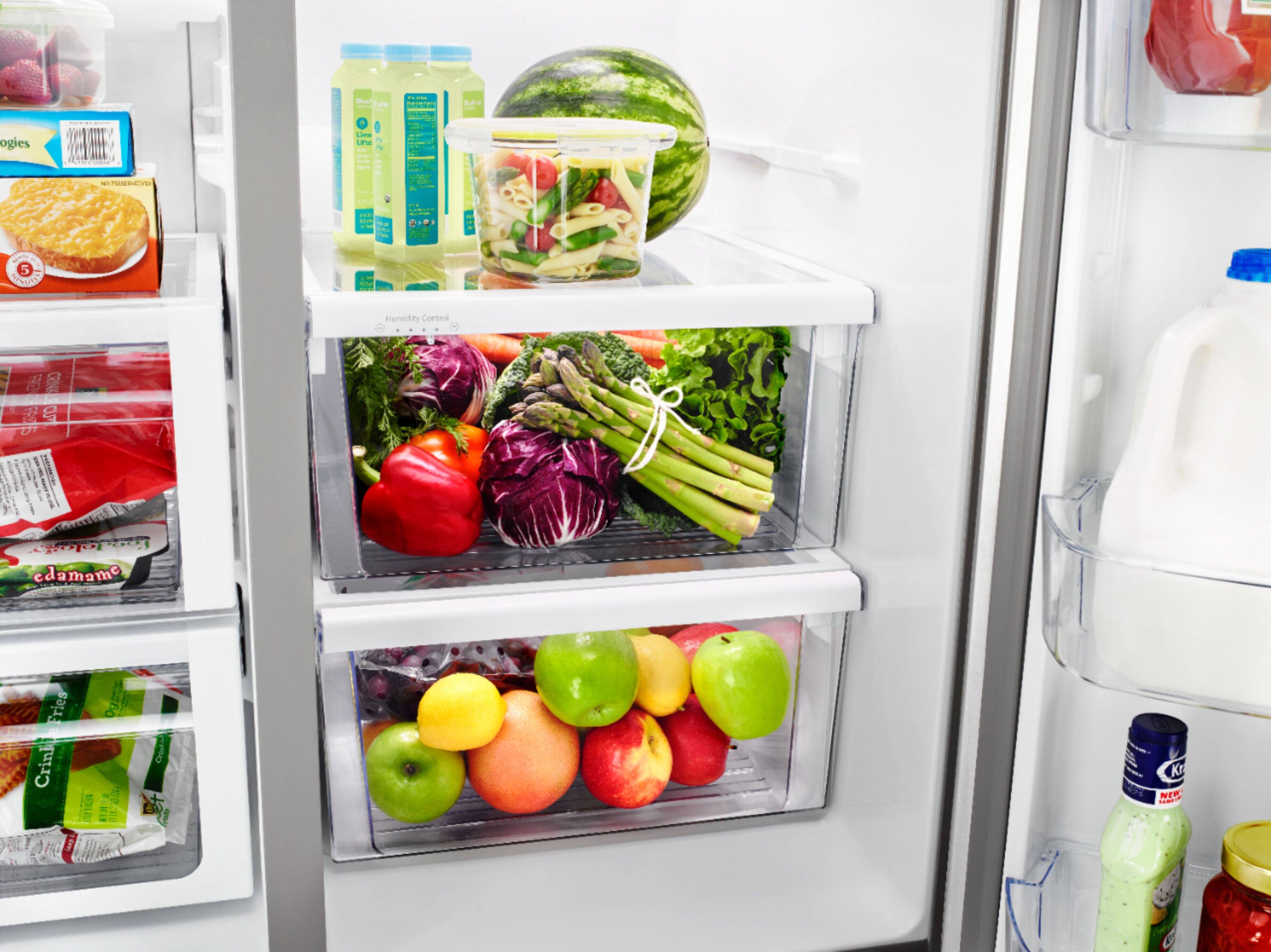 The image features a refrigerator filled with various food items, including a bowl of fruit, a bottle of water, and multiple bottles of beer. The refrigerator is stocked with a diverse assortment of food and drinks, making it a well-stocked and organized space. The presence of a variety of items in the refrigerator suggests that the owner has a diverse range of preferences and needs when it comes to their food and beverage choices.