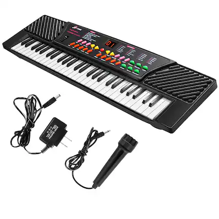 The image features a keyboard, microphone, and adapter. The keyboard is black and white, and the microphone is black. The adapter is also black and is placed next to the keyboard. The overall scene suggests that this is a musical setup, possibly for a performance or recording session.
