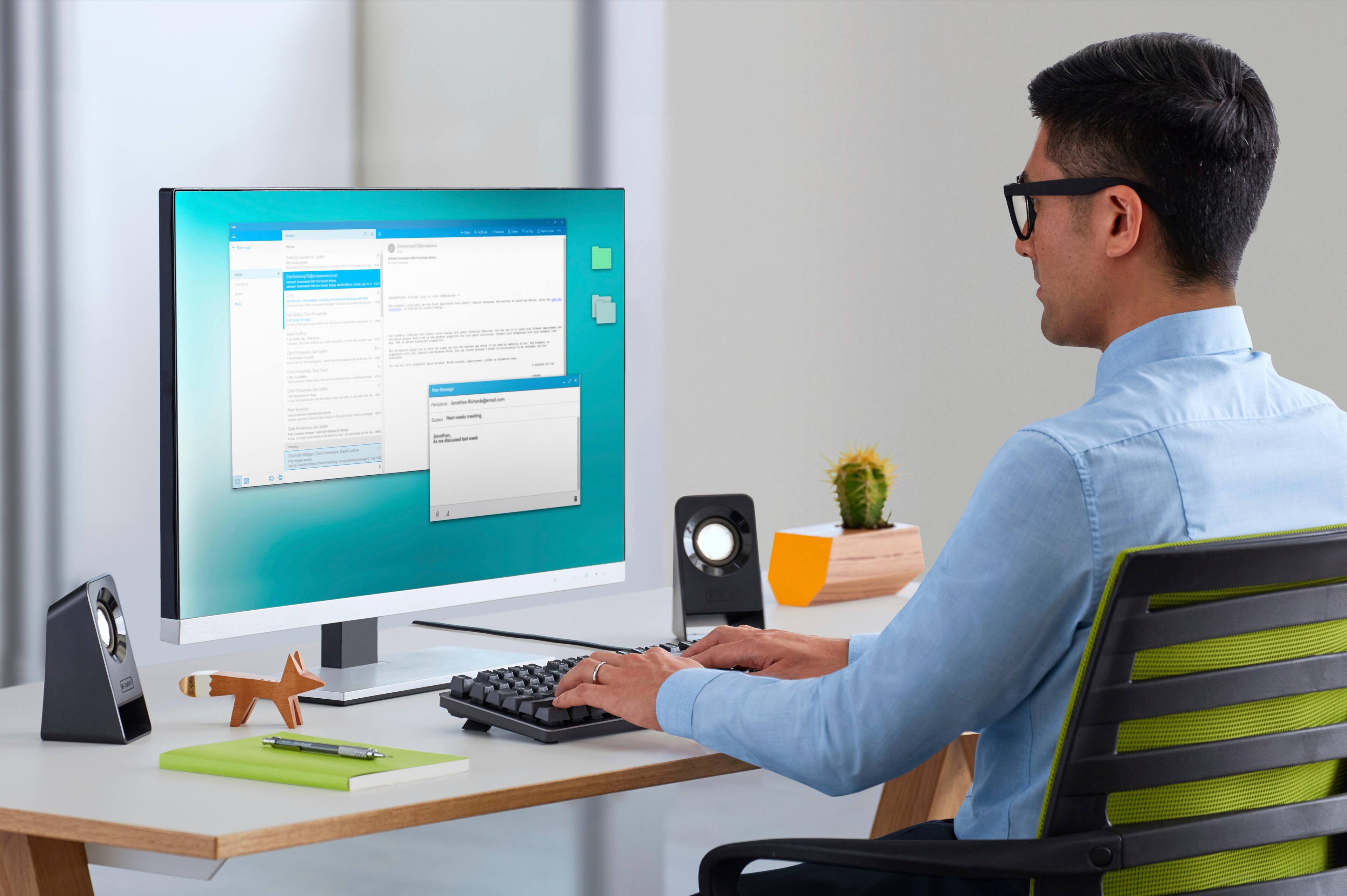 The text on the image is a jumbled mess, but it appears to be a description of a man using a computer. Here is a corrected version of the text:
"A man is sitting at a desk, working on a computer. He is wearing glasses and typing on a keyboard. The computer screen is in front of him, and there is a cup nearby. The man is focused on his work, and the scene suggests a productive work environment."