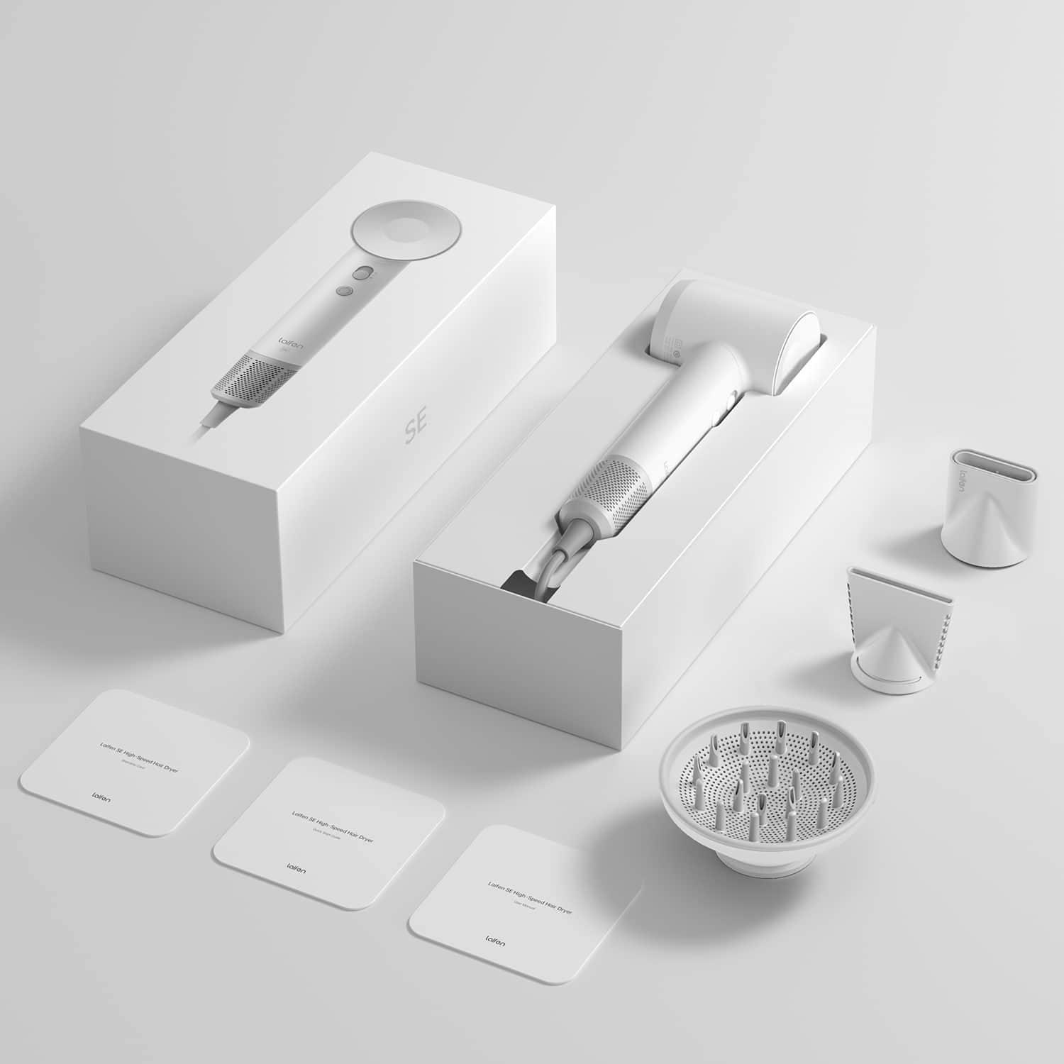 The image shows a white box containing a hair dryer and its accessories. The box is placed on a white background, and the hair dryer is positioned in the center of the box. The accessories include a brush and a small white cup, which are placed on the right side of the box. The overall scene presents a neat and organized display of the hair dryer and its accompanying items.