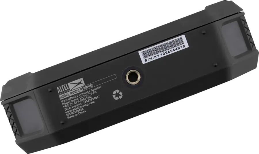 The image shows a black electronic device with a barcode label on it. The barcode contains the numbers "00011M2," which is the device's identification number. The device is made in China and has a power input of DC 5V. The manufacturer's website is listed as [www.alteclansing.com](http://www.alteclansing.com), and the device is supported by the FCC.