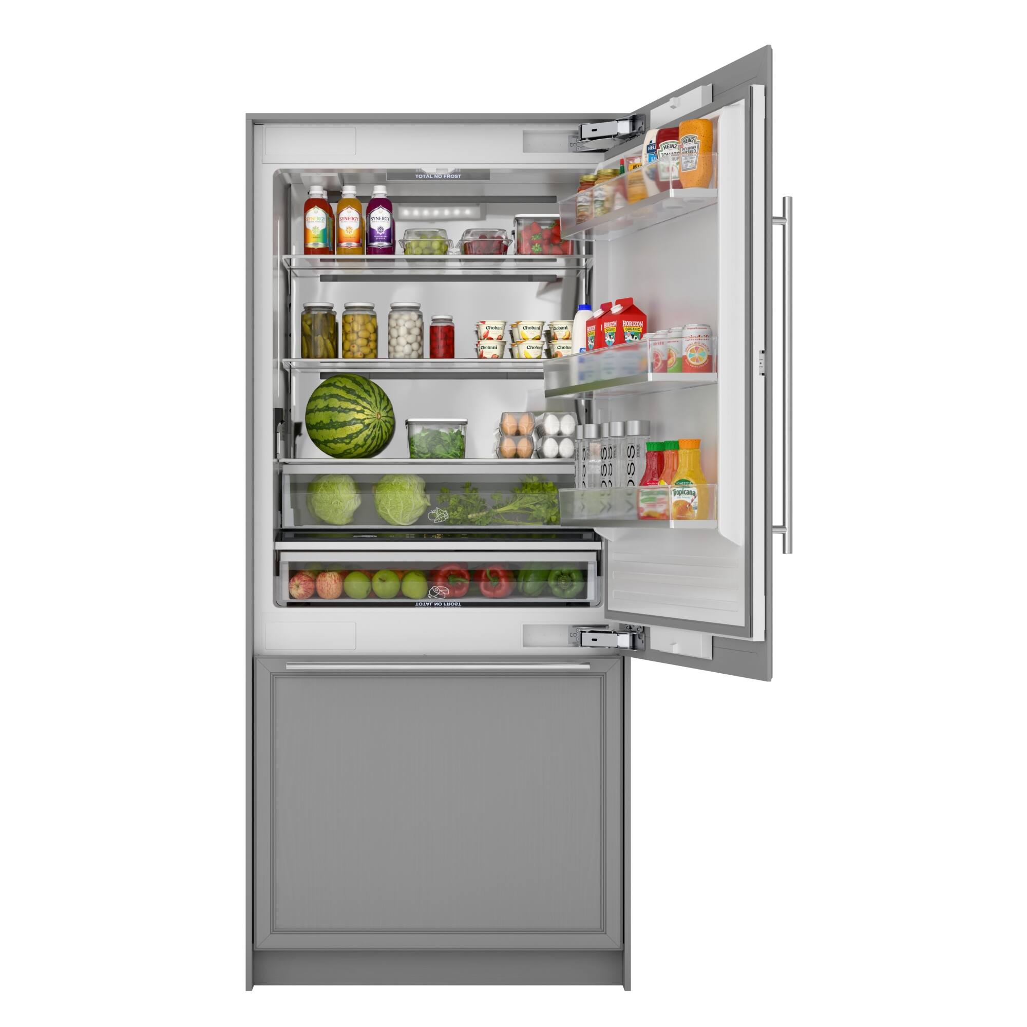 The refrigerator is filled with various food items, including fruits and vegetables. There are several bottles on the shelves, and a bowl of watermelon is placed in the middle of the refrigerator. The refrigerator is open, revealing the contents inside.