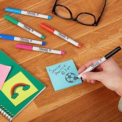 Sure, here is the corrected and grouped text:

**Sharpie Markers:**
- Sharpie
- Sharpie
- Sharpie
- Sharpie

**Note:**
- Soccer Practice @ 3 pm

**Other Items:**
- Notebook with rainbow and clover drawing
- Pink sticky note
- Black glasses
- Soccer ball illustration on the note