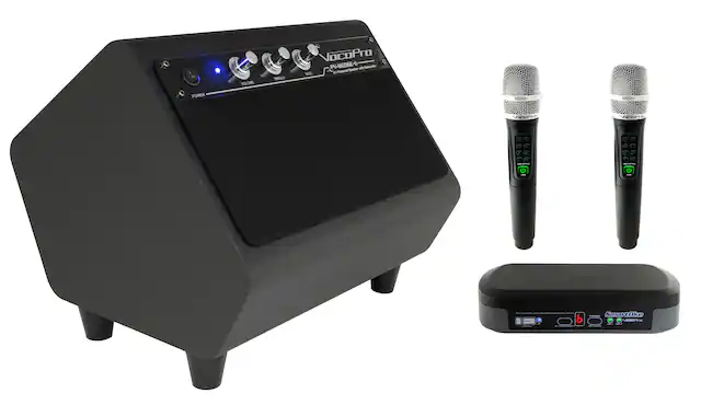 The image shows a VocoPro PV-WEDGE-II speaker system, which includes a speaker, a microphone, and a power supply. The speaker is placed on a stand, and the microphone is positioned next to it. The power supply is also present in the scene. The arrangement of these items suggests that this setup is designed for a professional sound system, possibly for events or performances.