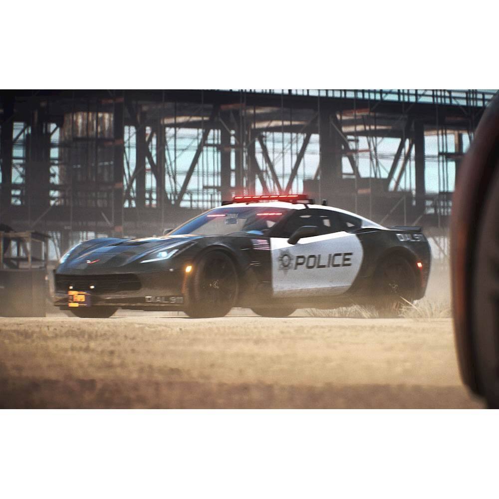 The image features a police car with its lights on, driving down a dirt road. The car is a sports car, and it is moving quickly, possibly in response to an emergency or pursuing a suspect. The scene takes place in a desert-like environment, with a bridge visible in the background. The police car is the main focus of the image, and it is driving on the dirt road with its lights on, indicating that it is in action.