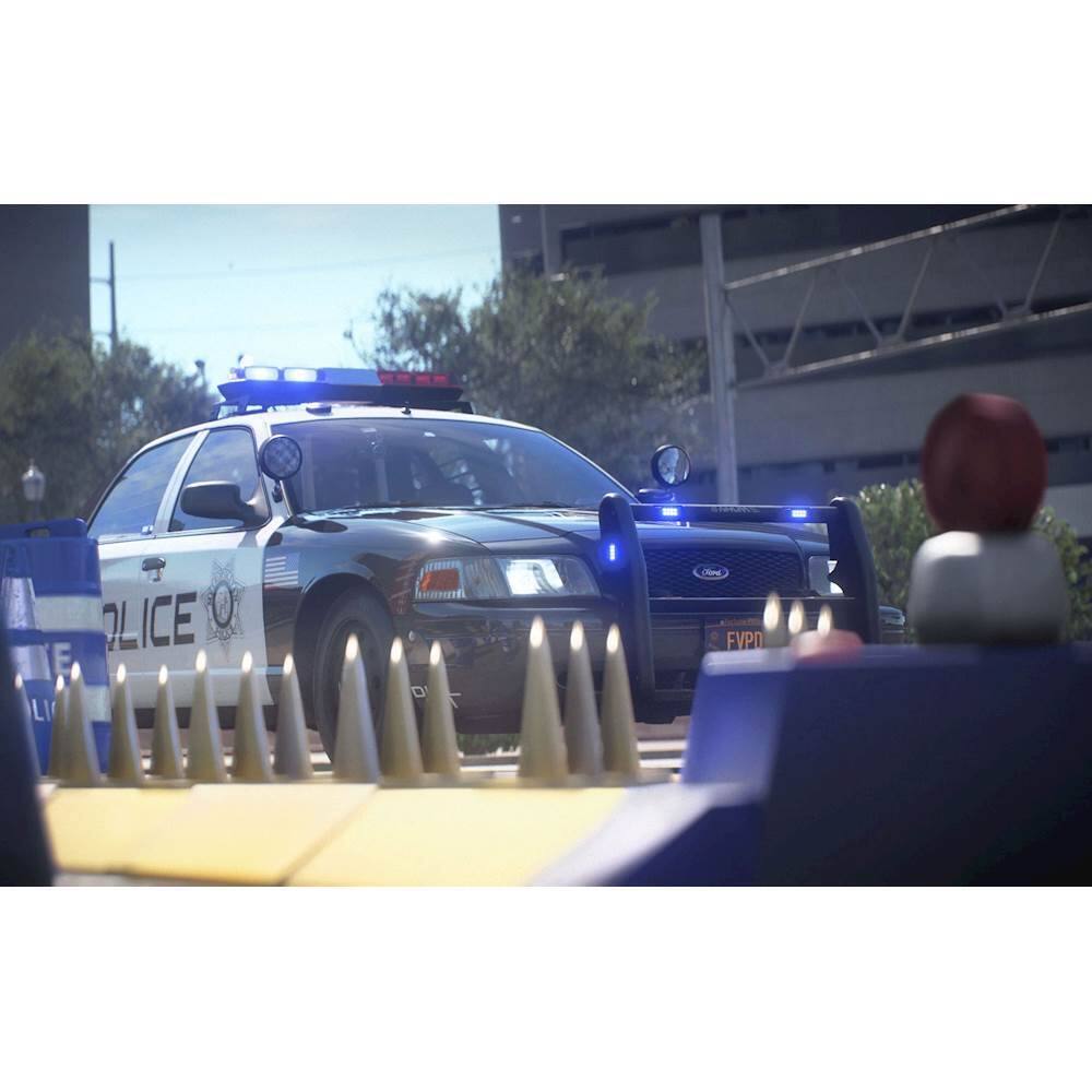 The image features a police car parked on a street, surrounded by traffic cones. The car is blue and white, and it is positioned in front of a building. The scene appears to be a training exercise, as the police car is driving through a course with traffic cones. The police car is also equipped with a siren, which is likely used for emergency situations or to control traffic.