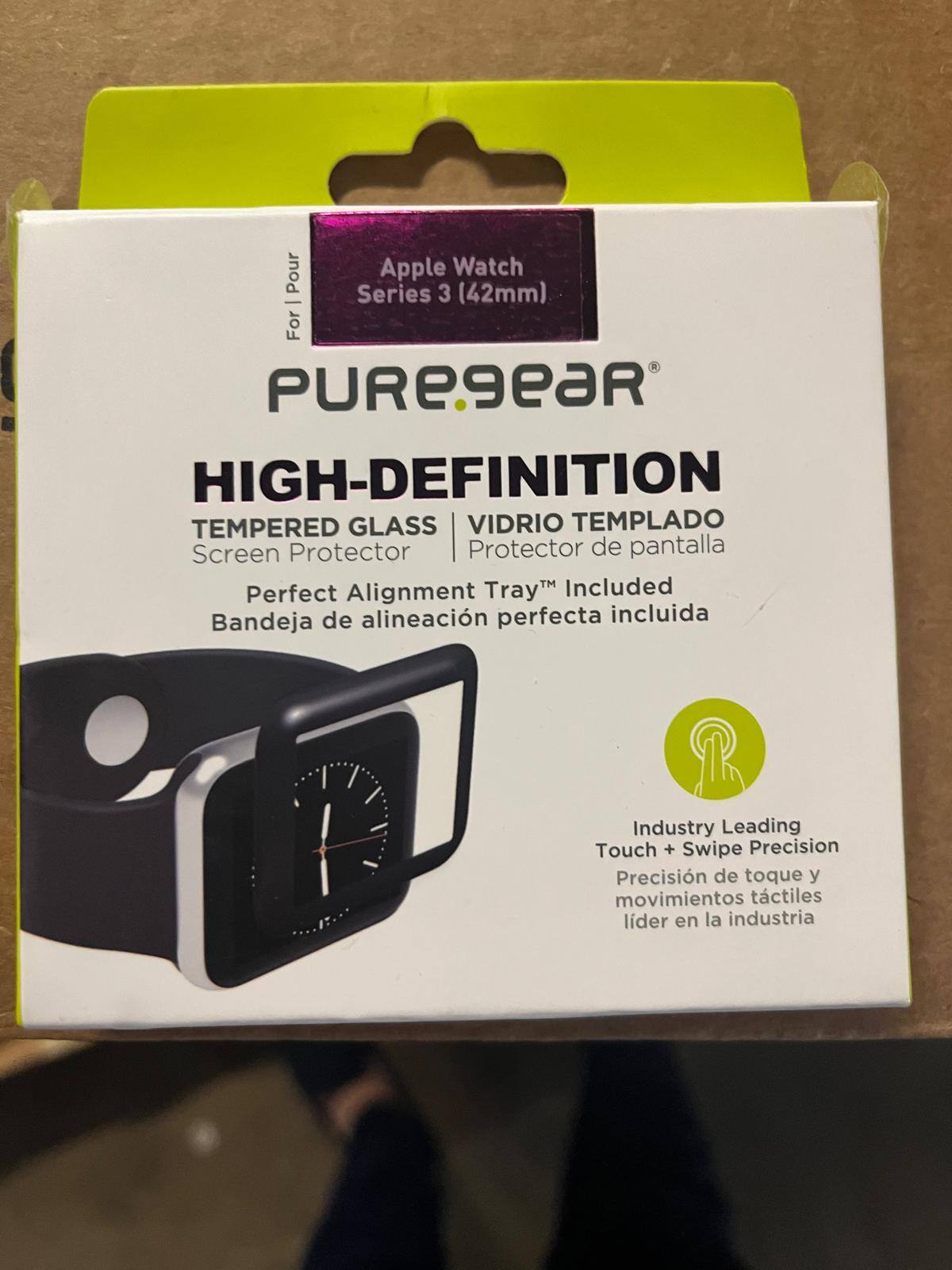 Sure, here is the corrected and grouped text from the image:

---

**For Apple Watch Series 3 (42mm)**

**PUREGEAR**

**HIGH-DEFINITION**

**TEMPERED GLASS**  
**VIDRIO TEMPLADO**  
**Screen Protector**  
**Protector de pantalla**

**Perfect Alignment Tray™ Included**  
**Bandeja de alineación perfecta incluida**

**Industry Leading Touch + Swipe Precision**  
**Precisión de toque y movimientos táctiles líder en la industria**

---