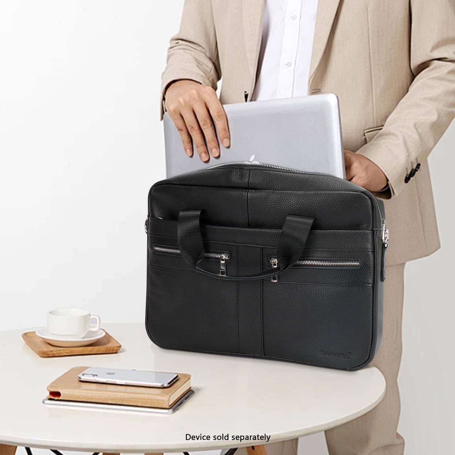 A man is standing next to a table with a laptop and a black bag on it. The bag is described as a "RAXA device sold separately."